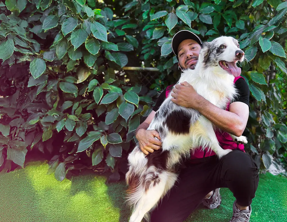 Tiago hugging a white dog
